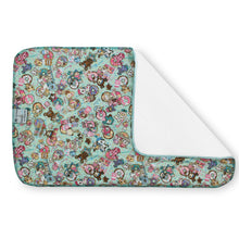 Load image into Gallery viewer, Kanga Care Changing Pad and Sheet Saver in the print called tokiTreats tokidoki Donutella with a colorful cartoon character print on a mint green background, shown with one corner folded over to reveal a white reverse side, on a white background.