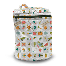 Load image into Gallery viewer, Kanga Care Wet Bag for cloth diapers in print Bloom featuring a colorful grid pattern of gardening and farm-themed icons such as watermelons, pumpkins, trowels, watering cans, and flowers, shown on a clean white background.