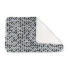Load image into Gallery viewer, Kanga Care Changing Pad and Sheet Saver in the print called Zev with a black, white, and gray chevron pattern, folded to show a soft white fleece backing, on a solid white background.