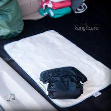 Load image into Gallery viewer, Phantom Rumparooz on a Changing Pad in the back of a car ready for a mobile diaper change.