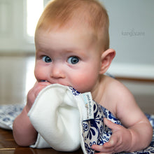 Load image into Gallery viewer, Baby teething on an Elskede Changing Pad