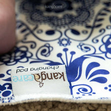 Load image into Gallery viewer, Elskede Changing Pad - zoomed in on the Kanga Care tag