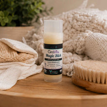 Load image into Gallery viewer, GroVia Magic Stick on a wooden surface with towels and a brush in the background