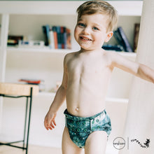 Load image into Gallery viewer, Toddler in Rumparooz G3 One Size Pocket Diaper in the deep teal and pine green print Stargazing