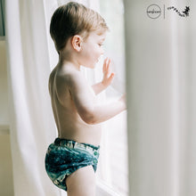 Load image into Gallery viewer, Toddler in Rumparooz G3 One Size Pocket Diaper in the deep teal and pine green print Stargazing
