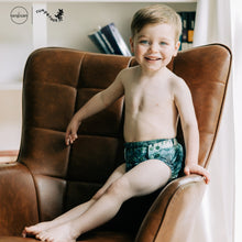 Load image into Gallery viewer, Toddler in Rumparooz G3 One Size Pocket Diaper in the deep teal and pine green print Stargazing
