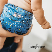 Load image into Gallery viewer, Wander Rumparooz One Size CLoth Pocket Diaper on a babies bum, being held by a parent