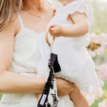 Load image into Gallery viewer, Baby holding a Unity Teething Blanket by the ring