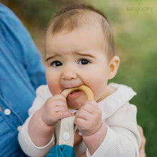 Load image into Gallery viewer, Baby chewing on a Lily teething blanket