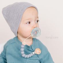 Load image into Gallery viewer, Baby with Graphite Paci Clip attached to their top and soother
