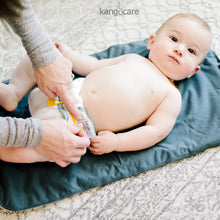Load image into Gallery viewer, Baby laying on a Kanga Care Changing Pad wearing a prefold