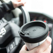 Load image into Gallery viewer, Polished SiliPint with lid being held in a car