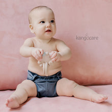 Load image into Gallery viewer, Baby sitting in a Castle Rumparooz cover, holding a Blush teething ring