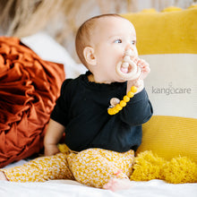 Load image into Gallery viewer, Baby with Saffron Paci Clip attached to their top and teether