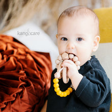Load image into Gallery viewer, Baby with Saffron Paci Clip attached to their top and teether