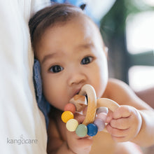 Load image into Gallery viewer, Baby chewing on a Rainbow Teething ring 
