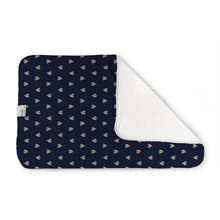Load image into Gallery viewer, Kanga Care Changing Pad and Sheet Saver in the print called Skipper with a repeating white sailboat pattern, shown with one corner folded over to reveal a soft white reverse side, on a clean white background.

