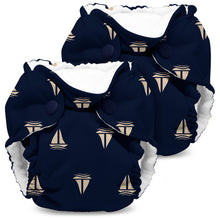 Load image into Gallery viewer, Lil Joey Newborn and preemie AIO cloth Diaper by Kanga Care in Skipper with navy blue with a beige sailboat pattern, featuring a white fleece lining and snap closures, shown on a white background.
