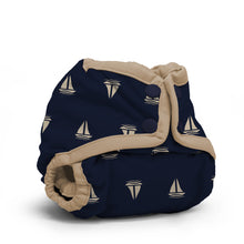 Load image into Gallery viewer, Rumparooz Newborn Cloth Diaper Cover by Kanga Care in the print called Skipper with a navy blue background printed with a beige sailboat pattern, featuring beige trim and snap closures, shown on a white background.
