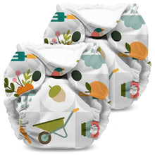 Load image into Gallery viewer, Lil Joey Newborn and preemie AIO cloth Diaper by Kanga Care in Bloom with a white base and a colorful garden-themed print featuring carrots, acorns, a wheelbarrow, a watering can, and gardening tools, shown on a plain white background.

