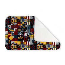 Load image into Gallery viewer, Kanga Care Changing Pad and Sheet Saver in the print called Hans Nutcracker with a colorful patchwork design featuring nautical and maritime-themed illustrations, shown with one corner folded over to reveal a white backing, on a solid white background.

