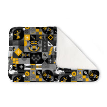 Load image into Gallery viewer, Kanga Care Changing Pad and Sheet Saver in the print called King Nutcracker with a black, gray, and yellow geometric pattern, shown with one corner folded over to reveal a white backing, on a solid white background
