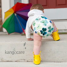Load image into Gallery viewer, Baby wear a Rumparooz One Size Cloth Diaper in the Clover print crawling up stairs with a rainbow umbrella in the background
