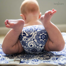 Load image into Gallery viewer, Elskede Rumparooz OBV cloth diaper on a baby on her belly with her feet up in the air, laying on an Elskede Changing Pad
