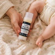 Load image into Gallery viewer, Person holding a Grovia Magic Stick next to a baby's foot on a soft fabric background
