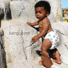 Load image into Gallery viewer, baby standing on rocks, with support from parent, wearing an I Love RAR Rumparooz 
