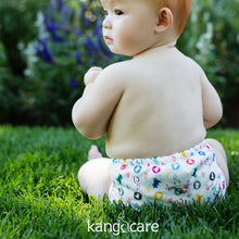 Load image into Gallery viewer, Baby sitting in the grass wearing Roozy Rumparooz 
