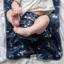 Load image into Gallery viewer, Baby wearing a Shine Bright Rumparooz, laying on a Shine Bright Changing Pad

