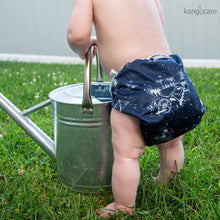 Load image into Gallery viewer, Baby standing outside holding onto a metal watering can, wearing a Shine Bright Cover
