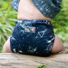 Load image into Gallery viewer, Baby sitting on a log outside, wearing a Shine Bright Rumparooz OBV  one size cloth diaper
