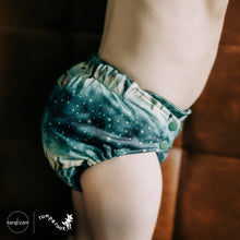 Load image into Gallery viewer, Toddler in Rumparooz G3 One Size Pocket Diaper in the deep teal and pine green print Stargazing
