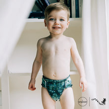 Load image into Gallery viewer, Toddler in Rumparooz G3 One Size Pocket Diaper in the deep teal and pine green print Stargazing
