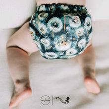 Load image into Gallery viewer, Baby wearing a dandelion cloth diaper, with 'Rumparooz' by Kanga Care branding visible.
