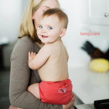 Load image into Gallery viewer, baby wearing a Spice Rumparooz being held by parent.
