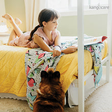 Load image into Gallery viewer, Child laying on a bed with a Radical Blanket
