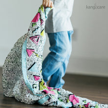 Load image into Gallery viewer, Child dragging a Radical baby blanket behind them
