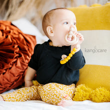 Load image into Gallery viewer, Baby with Saffron Paci Clip attached to their top and teether
