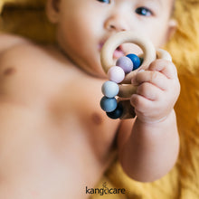 Load image into Gallery viewer, Baby holding a Rainbow Teething ring 
