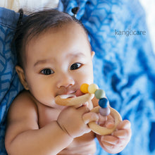 Load image into Gallery viewer, Baby chewing on a Rainbow Teething ring 
